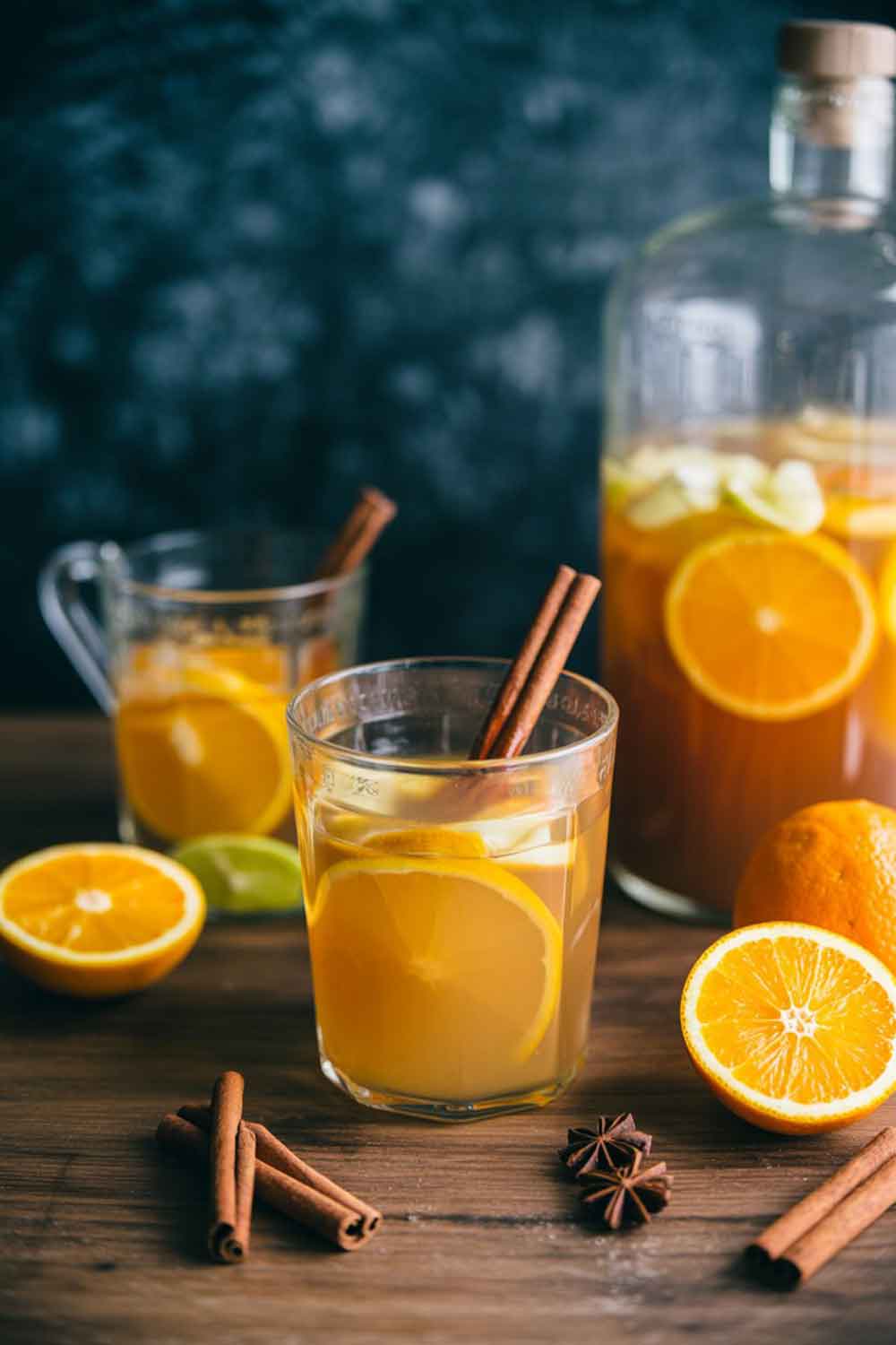 4. Spiced Citrus Rum Punch Warm spiced citrus rum punch with orange slices, cinnamon sticks, and star anise on a wooden table, ideal for festive gatherings or winter parties.